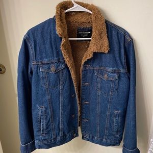 Dark denim jacket with brown fur on inside.